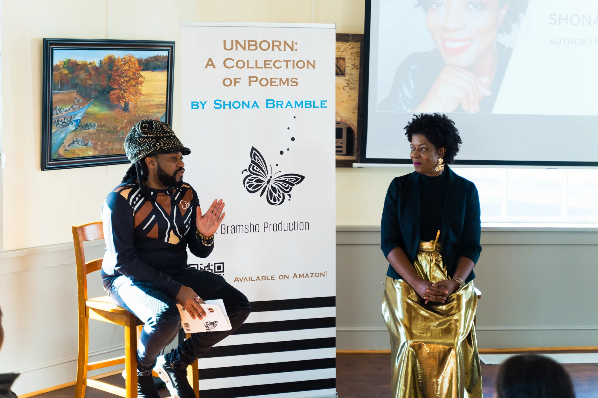 Shona Bramble in conversation on stage beside the Unborn banner.